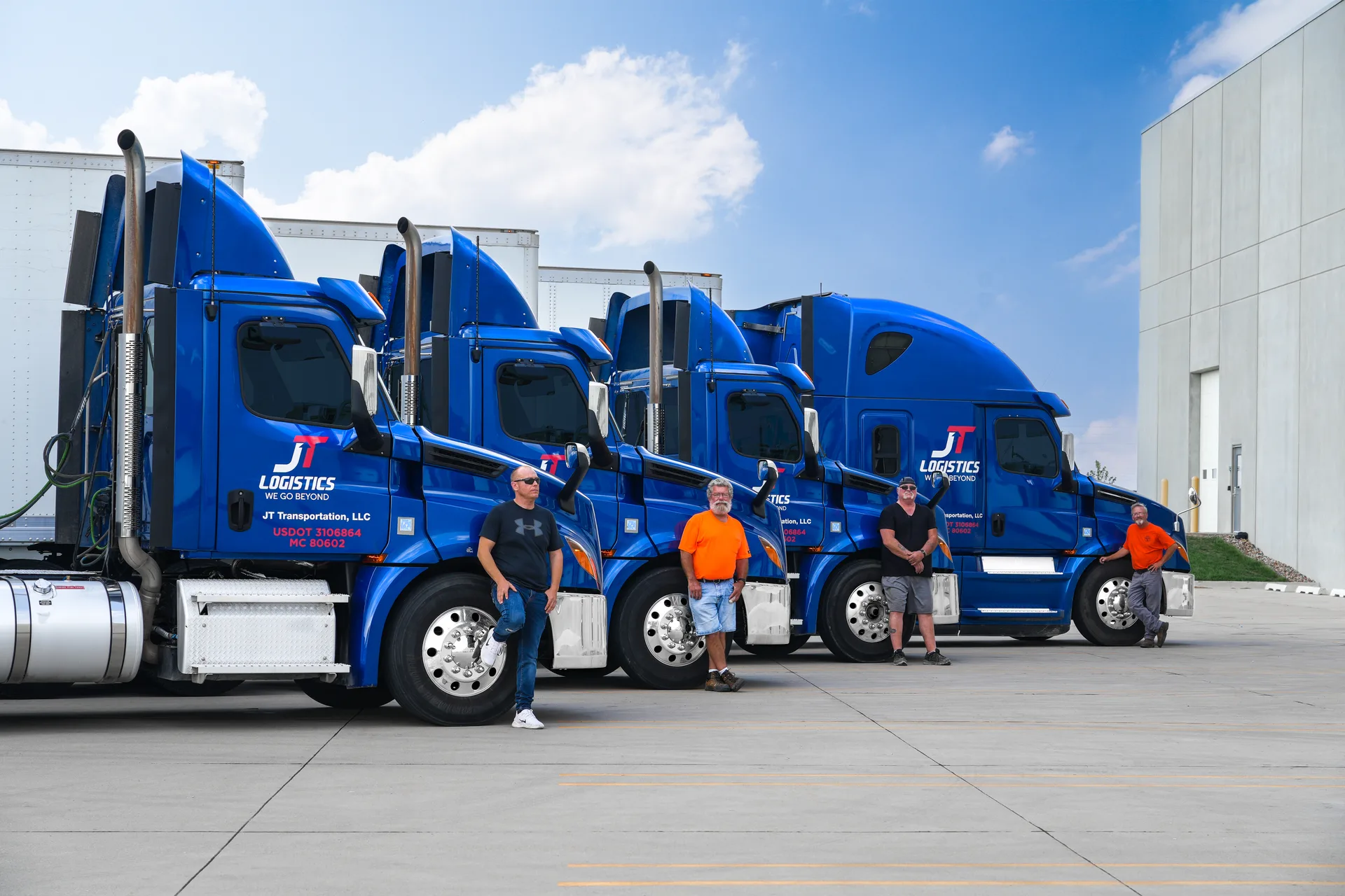 JT Logistics fleet drivers and trucks